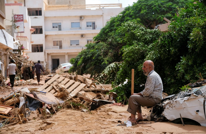 Old Man in Morocco sitting on a broken house after Earthquake